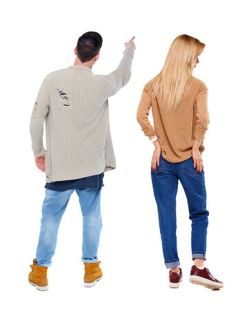 Back view of couple in sweater pointing. Rear view people collection. backside view of person. Isolated over white background.の写真素材