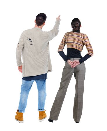 Back view of couple in sweater pointing. Rear view people collection. backside view of person. Isolated over white background.の写真素材