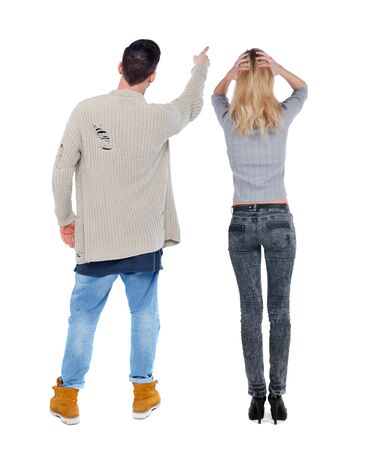 Back view of couple in sweater pointing. Rear view people collection. backside view of person. Isolated over white background.の写真素材