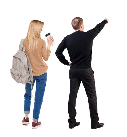 Back view of couple in sweater pointing. Rear view people collection. backside view of person. Isolated over white background.の写真素材