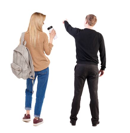 Back view of couple in sweater pointing. Rear view people collection. backside view of person. Isolated over white background.の写真素材