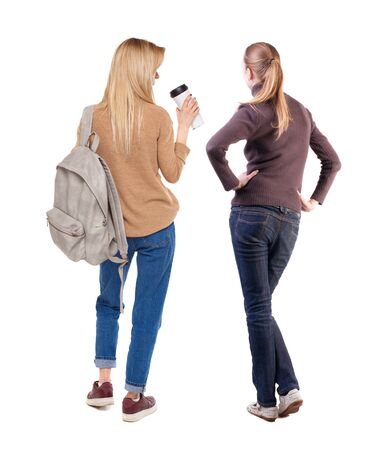Back view of two woman in sweater. Rear view people collection. backside view of person. Isolated over white background. Girls are looking forwardの写真素材