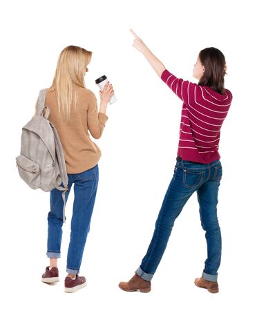 Back view of two pointing girl in sweater. Rear view people collection. backside view of person. beautiful woman showing gesture. Rear view. Isolated over white background.の写真素材
