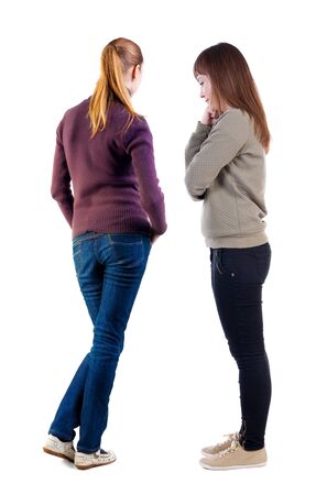 Back view of two woman in sweater. Rear view people collection. backside view of person. Isolated over white background. Girls are looking forwardの写真素材