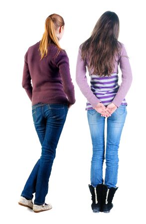 Back view of two woman in sweater. Rear view people collection. backside view of person. Isolated over white background. Girls are looking forwardの写真素材
