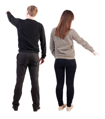 Back view of couple in sweater pointing. Rear view people collection. backside view of person. Isolated over white background.の写真素材