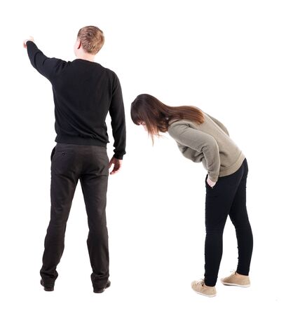 Back view of couple in sweater pointing. Rear view people collection. backside view of person. Isolated over white background.の写真素材