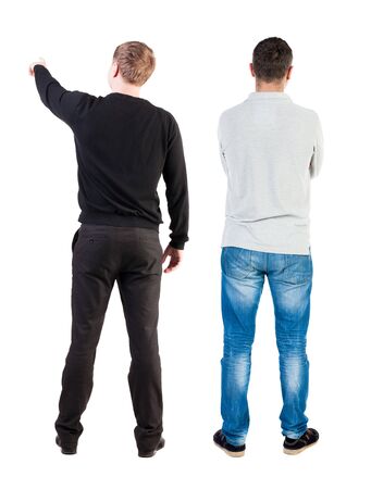 Back view of couple in sweater pointing. Rear view people collection. backside view of person. Isolated over white background.の写真素材