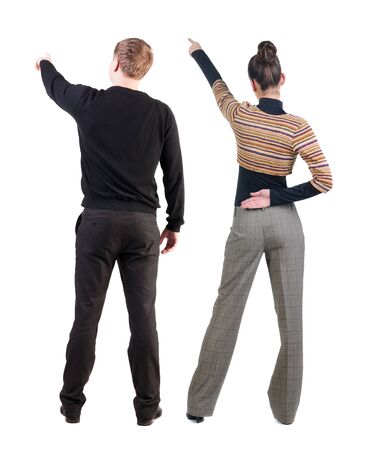 Back view of couple in sweater pointing. Rear view people collection. backside view of person. Isolated over white background.の写真素材