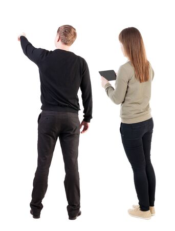 Back view of couple in sweater with mobile phone. beautiful friendly girl and guy together. Rear view people collection. backside view of person. Isolated over white background.の写真素材