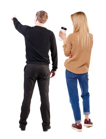 Back view of couple in sweater pointing. Rear view people collection. backside view of person. Isolated over white background.の写真素材