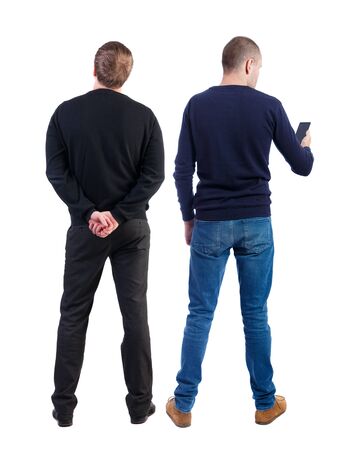 Back view of two man in sweater with mobile phone. Rear view people collection. backside view of person. Isolated over white background.の写真素材