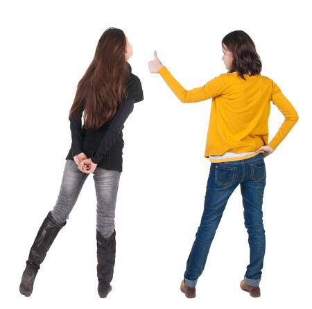 Back view of couple in sweater showing thumbs up. beautiful woman and man together. Rear view people collection. backside view of person. Isolated over white background.の写真素材