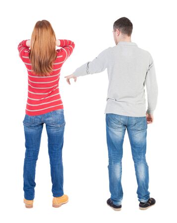 Back view of couple in sweater pointing. Rear view people collection. backside view of person. Isolated over white background.の写真素材