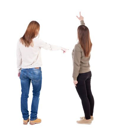 Back view of two pointing girl in sweater. Rear view people collection. backside view of person. beautiful woman showing gesture. Rear view. Isolated over white background.の写真素材