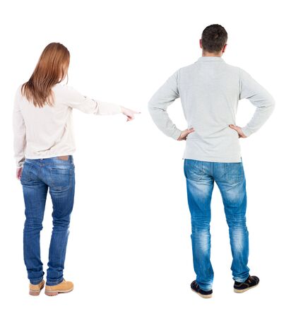 Back view of couple in sweater pointing. Rear view people collection. backside view of person. Isolated over white background.の写真素材