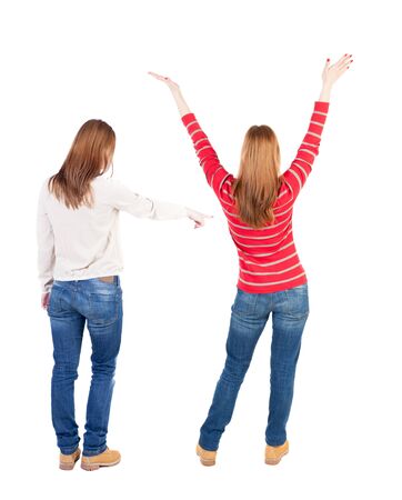 Back view of two pointing girl in sweater. Rear view people collection. backside view of person. beautiful woman showing gesture. Rear view. Isolated over white background.の写真素材