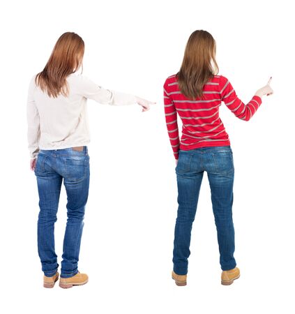 Back view of two pointing girl in sweater. Rear view people collection. backside view of person. beautiful woman showing gesture. Rear view. Isolated over white background.の写真素材