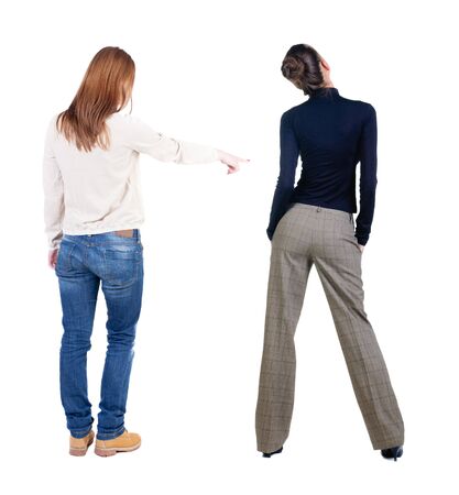 Back view of two pointing girl in sweater. Rear view people collection. backside view of person. beautiful woman showing gesture. Rear view. Isolated over white background.の写真素材