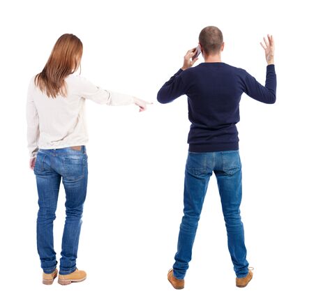 Back view of couple in sweater with mobile phone. Rear view people collection. backside view of person. Isolated over white background.の写真素材