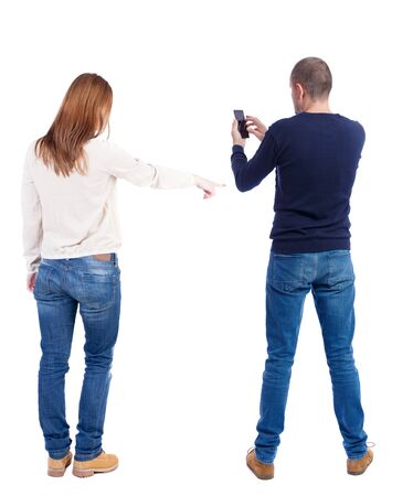 Back view of couple in sweater with mobile phone. Rear view people collection. backside view of person. Isolated over white background.の写真素材