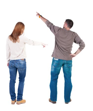 Back view of couple in sweater pointing. Rear view people collection. backside view of person. Isolated over white background.の写真素材