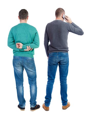 Back view of two man in sweater with mobile phone. Rear view people collection. backside view of person. Isolated over white background.の写真素材