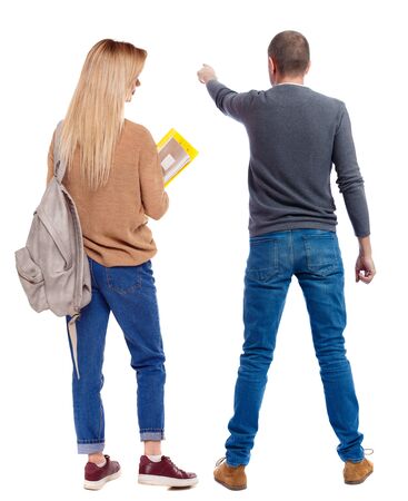 Back view of couple in sweater pointing. Rear view people collection. backside view of person. Isolated over white background.の写真素材