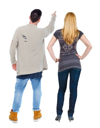 Back view of couple in sweater pointing. Rear view people collection. backside view of person. Isolated over white background.の写真素材