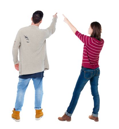 Back view of couple in sweater pointing. Rear view people collection. backside view of person. Isolated over white background.の写真素材