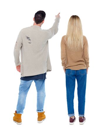 Back view of couple in sweater pointing. Rear view people collection. backside view of person. Isolated over white background.の写真素材