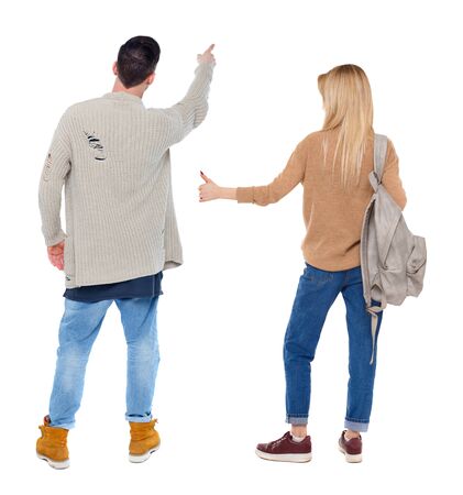 Back view of couple in sweater pointing. Rear view people collection. backside view of person. Isolated over white background.の写真素材
