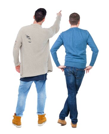 Back view of two man in sweater pointing. Rear view people collection. backside view of person. Isolated over white background.の写真素材