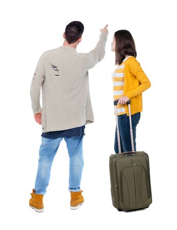 young couple in sweater traveling with suitcas. Back view. Rear view people collection. backside view of person. Isolated over white background.の写真素材