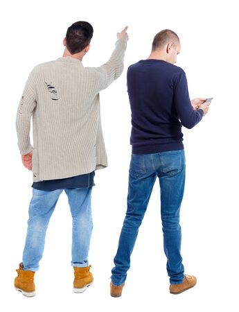 Back view of two man in sweater with mobile phone. Rear view people collection. backside view of person. Isolated over white background.の写真素材