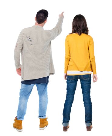 Back view of couple in sweater pointing. Rear view people collection. backside view of person. Isolated over white background.の写真素材