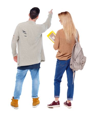 Back view of couple in sweater pointing. Rear view people collection. backside view of person. Isolated over white background.の写真素材