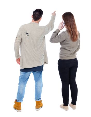 Back view of couple in sweater with mobile phone. Rear view people collection. backside view of person. Isolated over white background.の写真素材