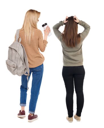 Back view of two woman in sweater. Rear view people collection. backside view of person. Isolated over white background.の写真素材