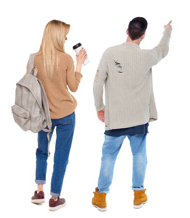 Back view of couple in sweater pointing. Rear view people collection. backside view of person. Isolated over white background.の写真素材