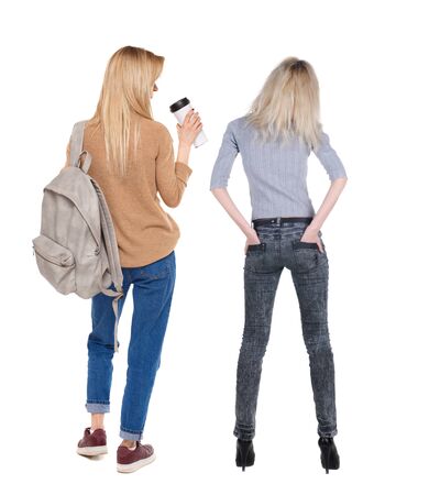 Back view of two woman in sweater. Rear view people collection. backside view of person. Isolated over white background.の写真素材