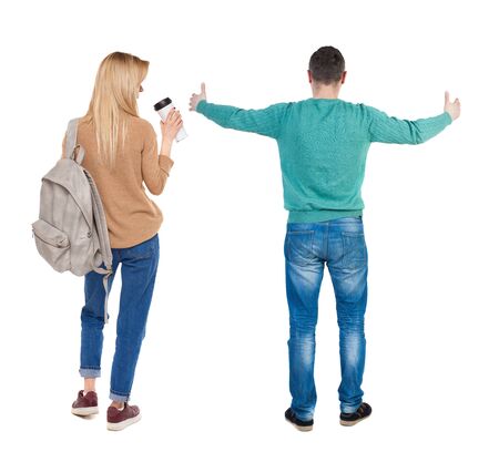 Back view of couple in sweater showing thumbs up. beautiful woman and man together. Rear view people collection. backside view of person. Isolated over white background.の写真素材