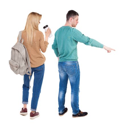 Back view of couple in sweater pointing. Rear view people collection. backside view of person. Isolated over white background.の写真素材