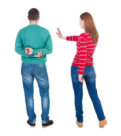 Back view of couple in sweater pointing. Rear view people collection. backside view of person. Isolated over white background.の写真素材