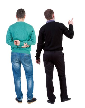 Back view of two man in sweater pointing. Rear view people collection. backside view of person. Isolated over white background.の写真素材