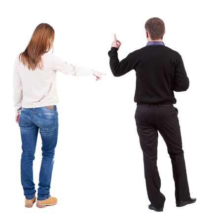 Back view of couple in sweater pointing. Rear view people collection. backside view of person. Isolated over white background.の写真素材