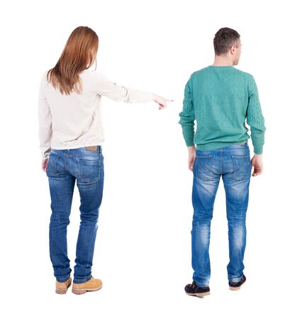 Back view of couple in sweater pointing. Rear view people collection. backside view of person. Isolated over white background.の写真素材