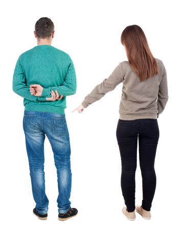 Back view of couple in sweater pointing. Rear view people collection. backside view of person. Isolated over white background.の写真素材