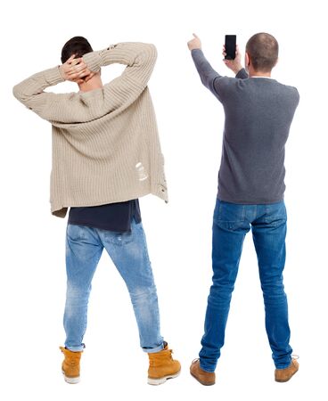 Back view of two man in sweater with mobile phone. Rear view people collection. backside view of person. Isolated over white background.の写真素材