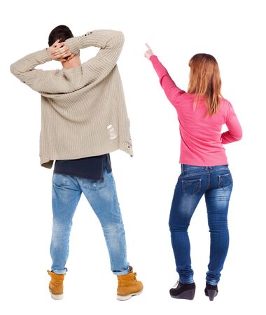 Back view of couple in sweater pointing. Rear view people collection. backside view of person. Isolated over white background.の写真素材